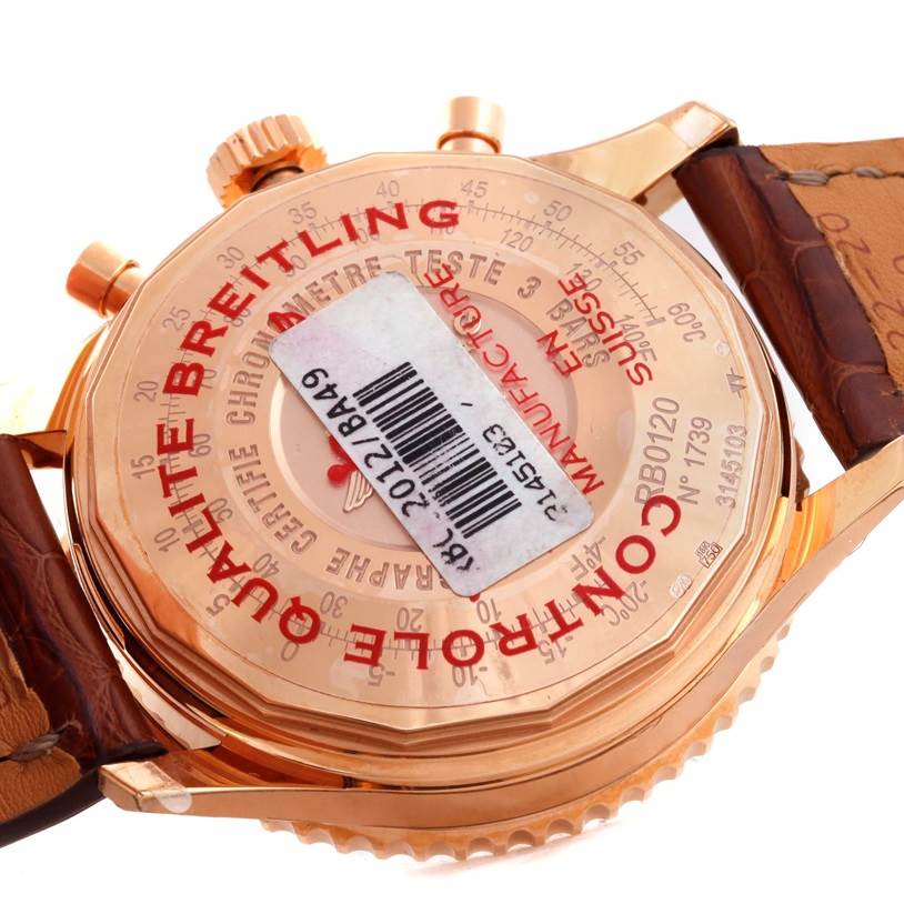 The image shows the back case of a Breitling Navitimer RB0120 Men's Rose Gold Black Dial RB0120 Men's Rose Gold Black Dial watch, highlighting various inscriptions and the strap attachment.