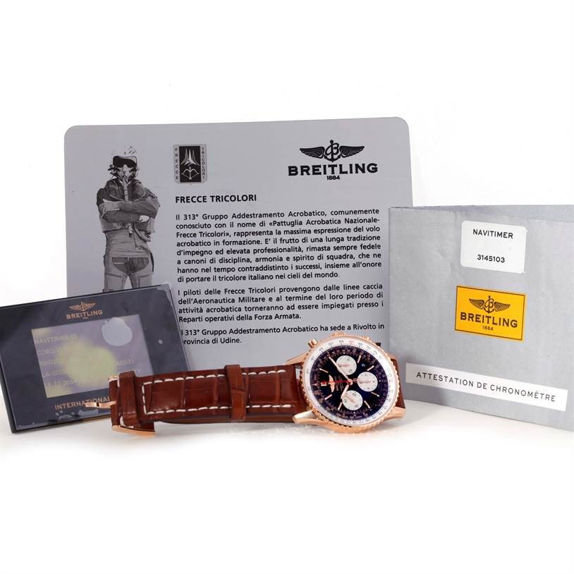 The image shows a Breitling Navitimer RB0120 Men's Rose Gold Black Dial RB0120 Men's Rose Gold Black Dial watch, leather strap, and documentation from a slightly above-angle.