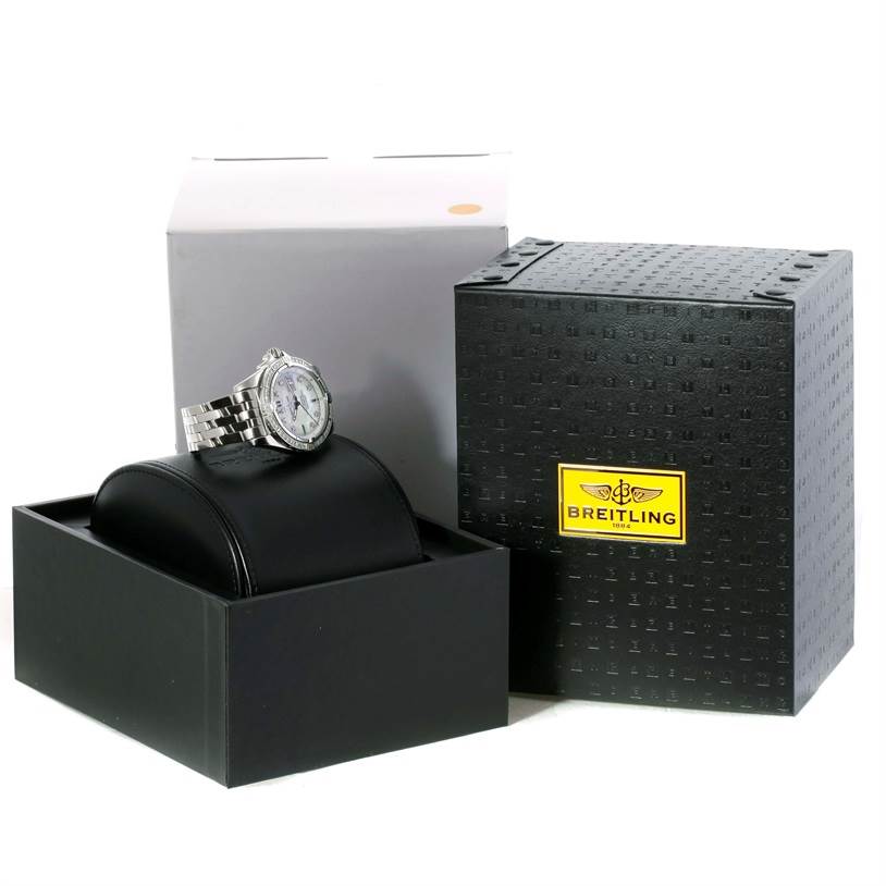 The image shows a Breitling Windrider A49350 Men's Stainless Steel Mother of Pearl Dial A49350 Men's Stainless Steel Mother of Pearl Dial watch at an oblique angle, along with its black display case and packaging.