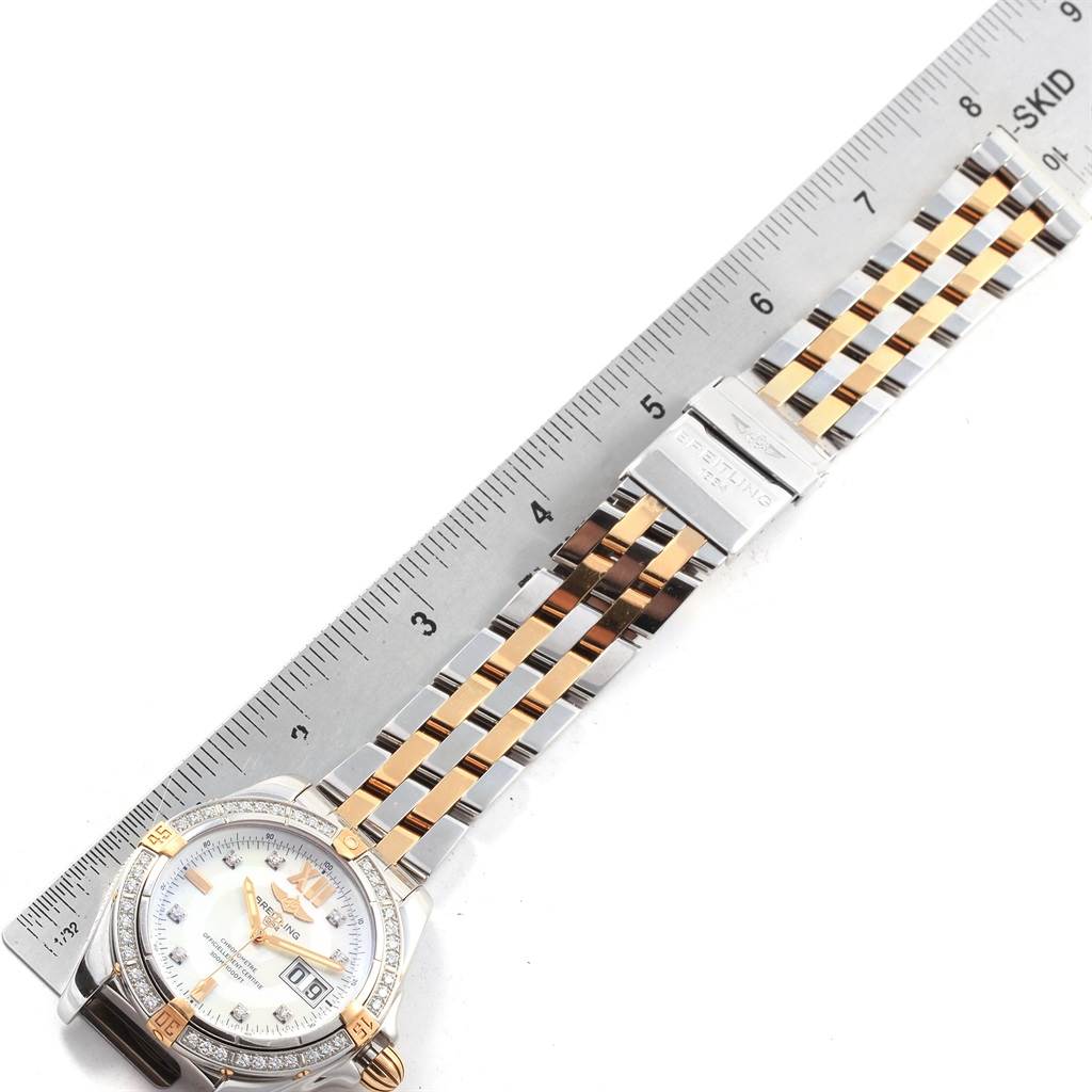 The image shows a Breitling Windrider B49350 Men's Stainless Steel Mother of Pearl Dial B49350 Men's Stainless Steel Mother of Pearl Dial watch, positioned flat, displaying the face, bezel, and partial two-tone bracelet next to a ruler.
