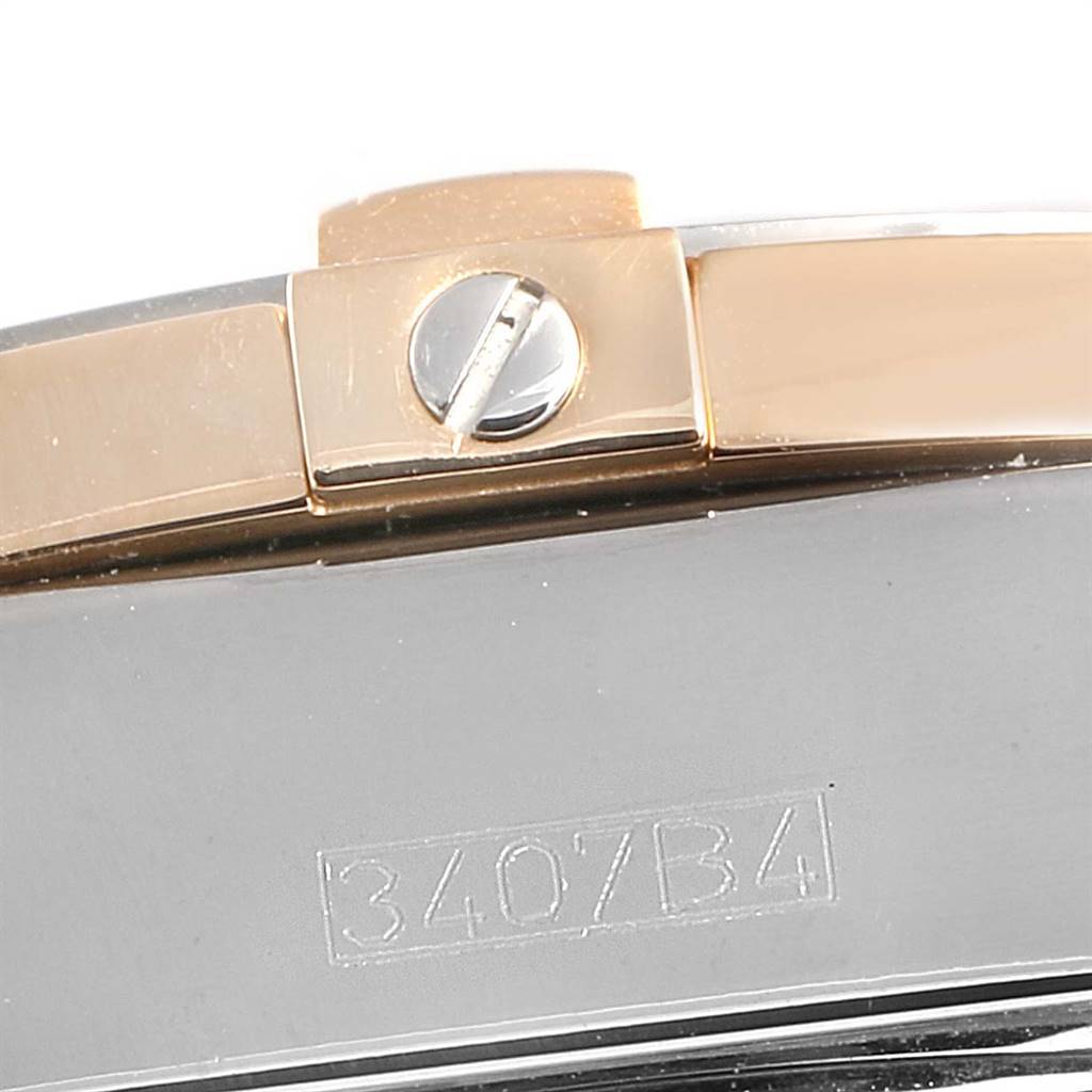 This image shows a close-up of the side of a Breitling Windrider C49350 Men's Steel and Gold (two tone) Champagne Dial C49350 Men's Steel and Gold (two tone) Champagne Dial watch, highlighting the bezel screw and engraved model number "3407/B4."