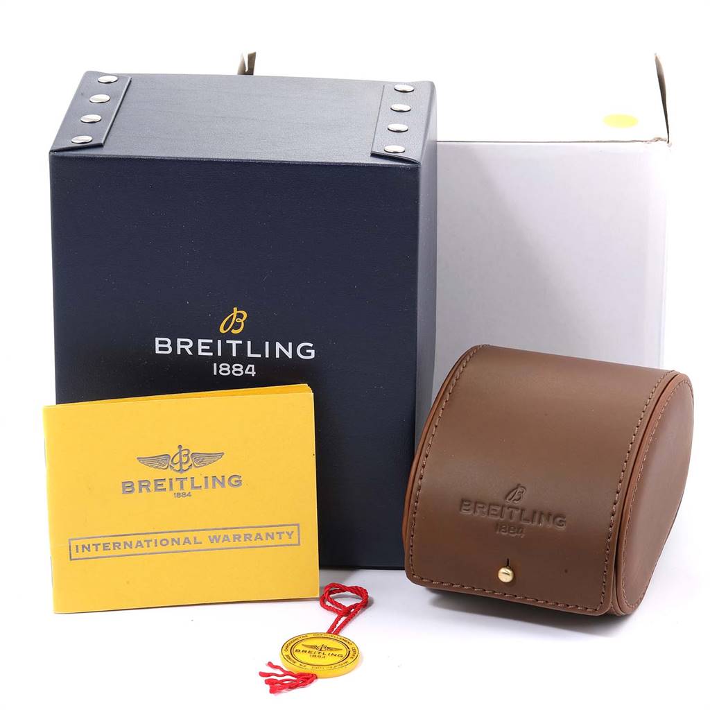 The image shows a Breitling Windrider C49350 Men's Steel and Gold (two tone) Champagne Dial C49350 Men's Steel and Gold (two tone) Champagne Dial watch box, a brown leather case, an international warranty booklet, and a tag.