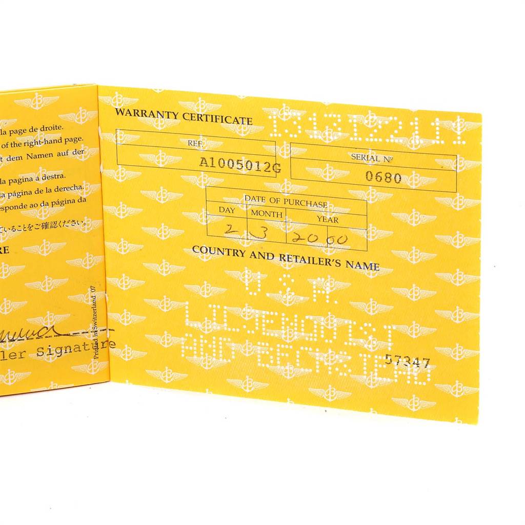 This image shows the inside of a yellow warranty certificate booklet for a Breitling Windrider A10050 Men
s Stainless Steel Black Dial A10050 Men
s Stainless Steel Black Dial model watch.