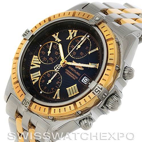 The image shows a Breitling Windrider D1335512 Men's Steel and Gold (two tone) Grey Dial D1335512 Men's Steel and Gold (two tone) Grey Dial watch at an angled close-up, highlighting its dial, bezel, pushers, and bracelet.