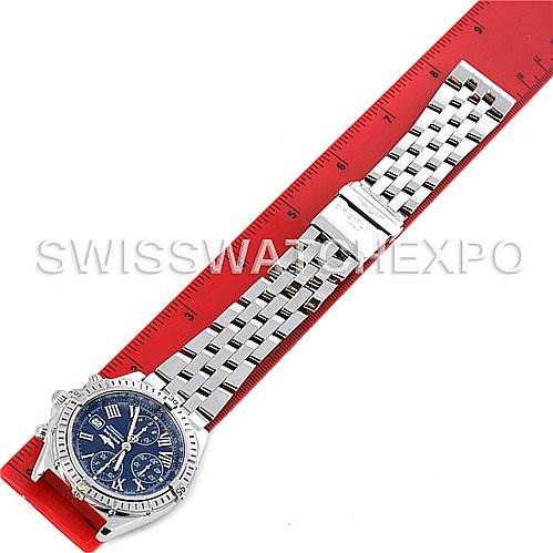 The image shows a top view of a Breitling Windrider A1335512 / C508 Men's Stainless Steel Blue Dial A1335512 / C508 Men's Stainless Steel Blue Dial watch with its band extended alongside a red ruler.