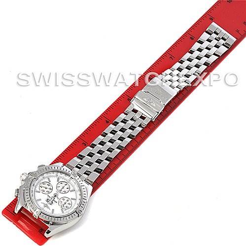 The image shows a Breitling Windrider A44355 Men's Stainless Steel White Dial A44355 Men's Stainless Steel White Dial watch laid flat on a red ruler, displaying the face and stainless steel bracelet.