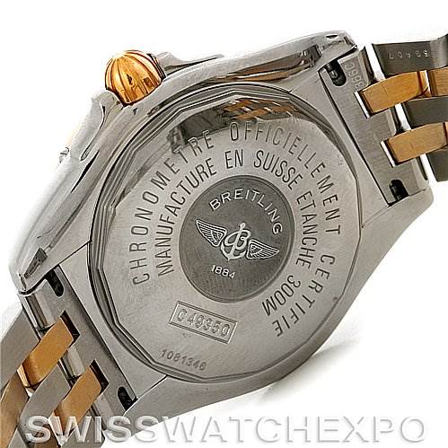 The image shows the back case of a Breitling Windrider C49350 Men's Steel and Gold (two tone) Black Dial C49350 Men's Steel and Gold (two tone) Black Dial watch, highlighting its inscription and part of the two-tone bracelet.
