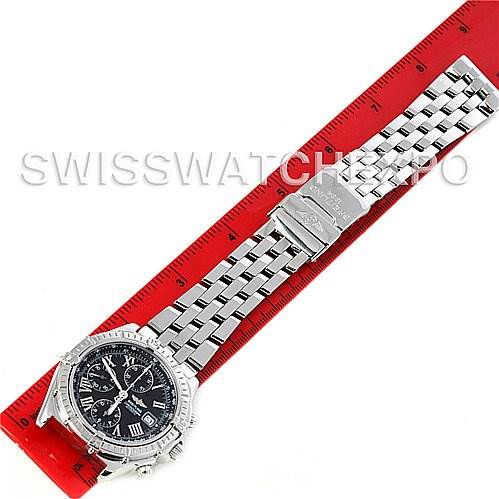 The Breitling Windrider A13055 Men's Stainless Steel Black Dial A13055 Men's Stainless Steel Black Dial watch is shown from a top-down angle, displaying its full bracelet, clasp, and face next to a red ruler for scale.