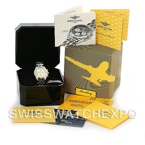 The image shows a Breitling Windrider B55048 Men's Steel and Gold (two tone) White Dial B55048 Men's Steel and Gold (two tone) White Dial watch at an angle inside its open box, with accompanying manuals and packaging displayed.
