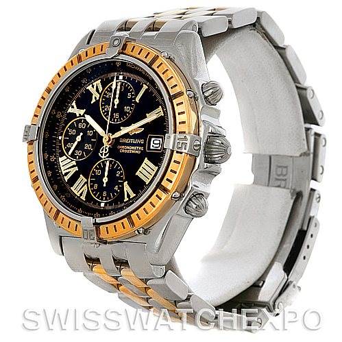 This Breitling Windrider D1335512 Men's Steel and Gold (two tone) Black Dial D1335512 Men's Steel and Gold (two tone) Black Dial model watch is shown at an angle highlighting the face, bezel, and part of the bracelet.