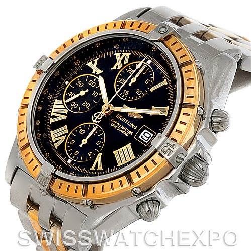 The image shows a Breitling Windrider D1335512 Men's Steel and Gold (two tone) Black Dial D1335512 Men's Steel and Gold (two tone) Black Dial watch from an oblique angle, highlighting its bezel, crown, dial, and chronograph sub-dials.