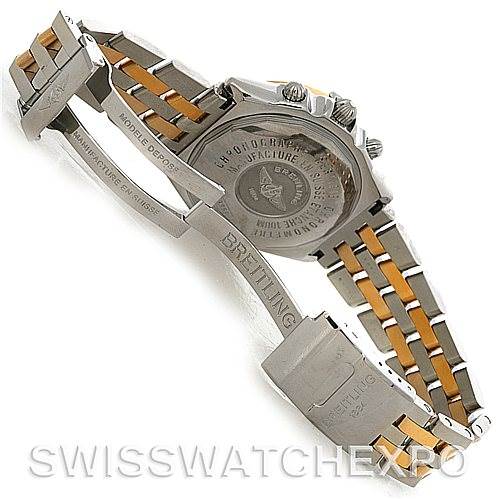 The image shows the back case and clasp of a Breitling Windrider D1335512 Men's Steel and Gold (two tone) Black Dial D1335512 Men's Steel and Gold (two tone) Black Dial watch at an angle that highlights the bracelet and engraving details.