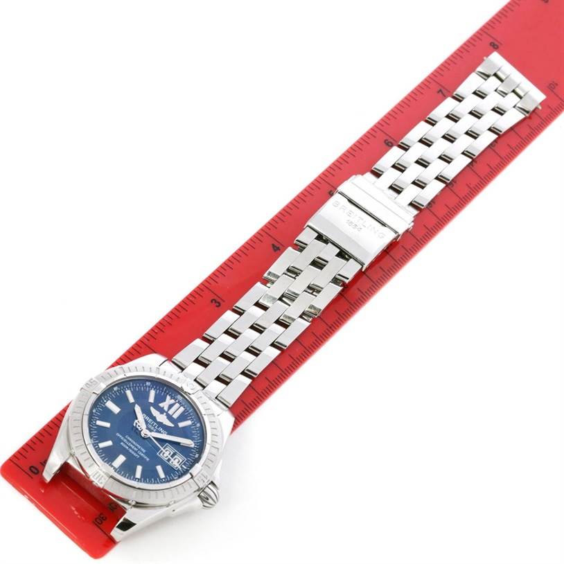 This image shows a Breitling Windrider A49350 Men
s Stainless Steel Blue Dial A49350 Men
s Stainless Steel Blue Dial watch displayed flat, showcasing its face and metal bracelet alongside a ruler for scale.