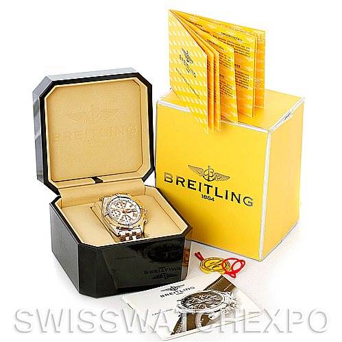 The image shows a Breitling Windrider D13055 Men
s Stainless Steel White Dial D13055 Men
s Stainless Steel White Dial watch in its open black box, alongside yellow packaging, booklets, and tags in full view.