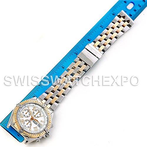 The image shows a top view of the Breitling Windrider D13055 Men
s Stainless Steel White Dial D13055 Men
s Stainless Steel White Dial watch with the band fully extended and placed next to a ruler for scale.