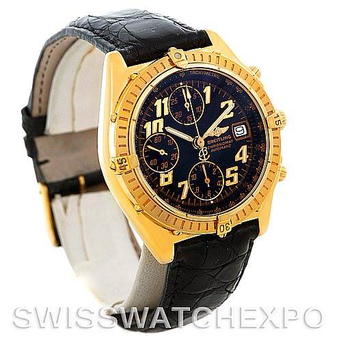 This Breitling Windrider model watch is shown at a slight angle, displaying its black leather strap, gold case, and black dial with three subdials.