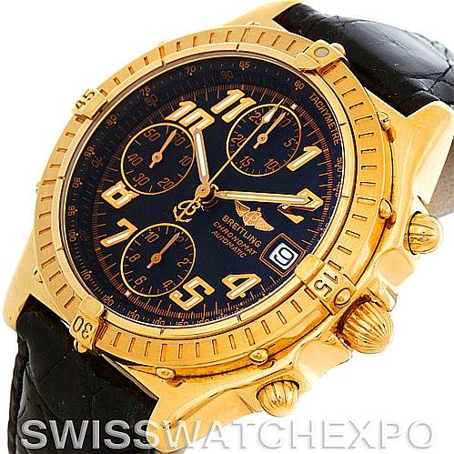 The image shows a Breitling Windrider K13350 Men's Steel and Gold (two tone) Black Dial K13350 Men's Steel and Gold (two tone) Black Dial watch from an angled, front-left perspective, highlighting the gold case, black dial, and chronograph subdials.