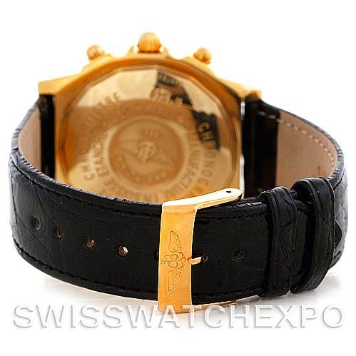 The image shows the back of a Breitling Windrider K13352 Men's Yellow Gold Black Dial K13352 Men's Yellow Gold Black Dial watch, including the case back and leather strap with a gold clasp.