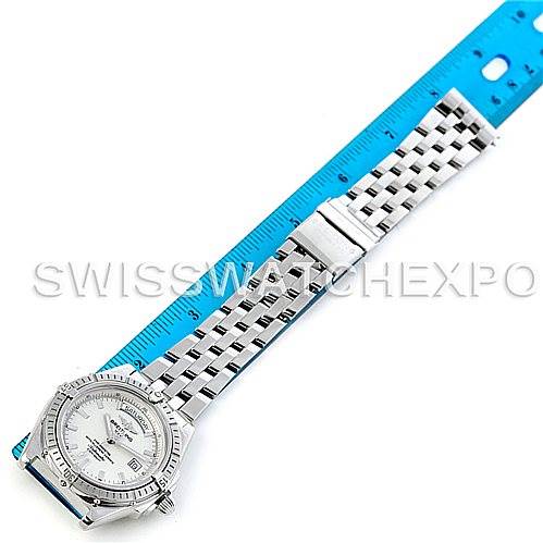 The image shows a top view of the Breitling Windrider A45355 Men's Stainless Steel White Dial A45355 Men's Stainless Steel White Dial watch with its stainless steel bracelet fully extended next to a blue ruler.