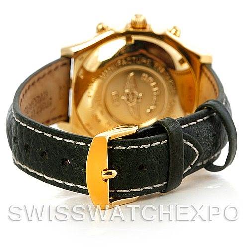 This image shows the back of a Breitling Windrider K13048 Men's Yellow Gold White Dial K13048 Men's Yellow Gold White Dial watch, focusing on the gold case back and the black leather strap with a gold buckle.