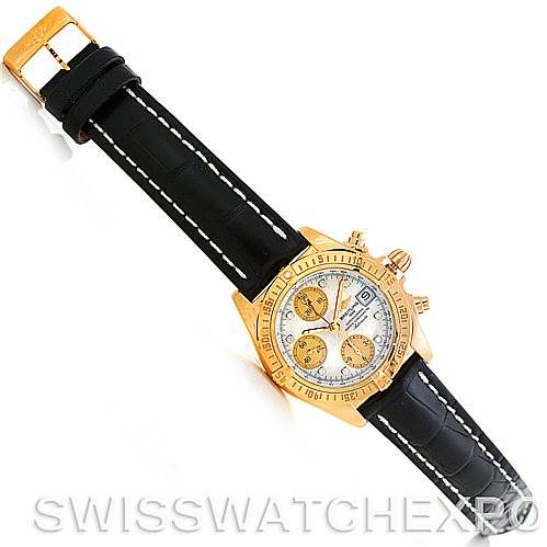 This image shows a Breitling Windrider K13358 Men's Yellow Gold Mother of Pearl Dial K13358 Men's Yellow Gold Mother of Pearl Dial watch at an angled top view, displaying its face, bezel, and leather strap.
