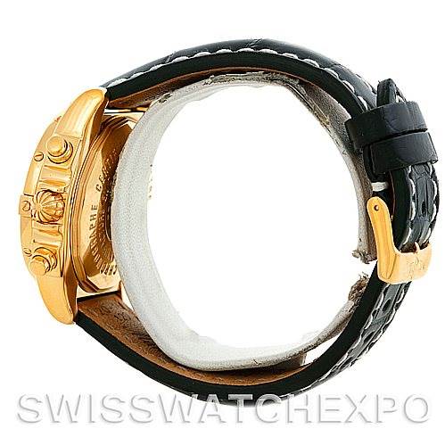 This side view of the Breitling Windrider K13358 Men's Yellow Gold Mother of Pearl Dial K13358 Men's Yellow Gold Mother of Pearl Dial watch shows its black strap, gold case, and clasp.