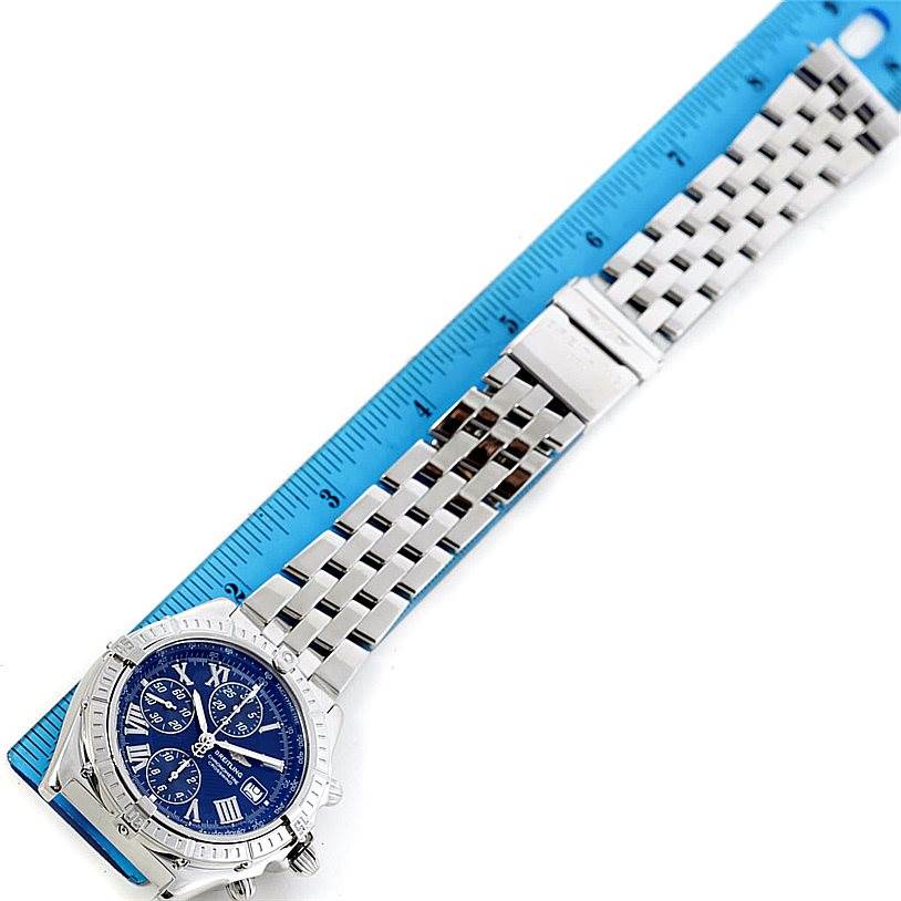 The Breitling Windrider A13355 Men's Stainless Steel Blue Dial A13355 Men's Stainless Steel Blue Dial watch is shown from a top-down angle, displaying its blue dial, metal bracelet, and part of the measuring scale.