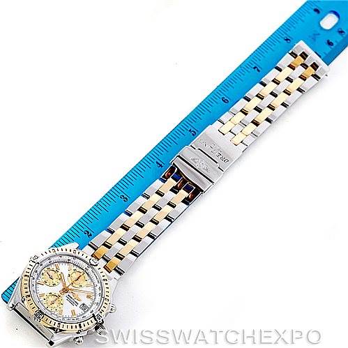 The image shows a Breitling Windrider D13352 Men's Stainless Steel Mother of Pearl Dial D13352 Men's Stainless Steel Mother of Pearl Dial watch laid flat next to a ruler, highlighting the band and face.