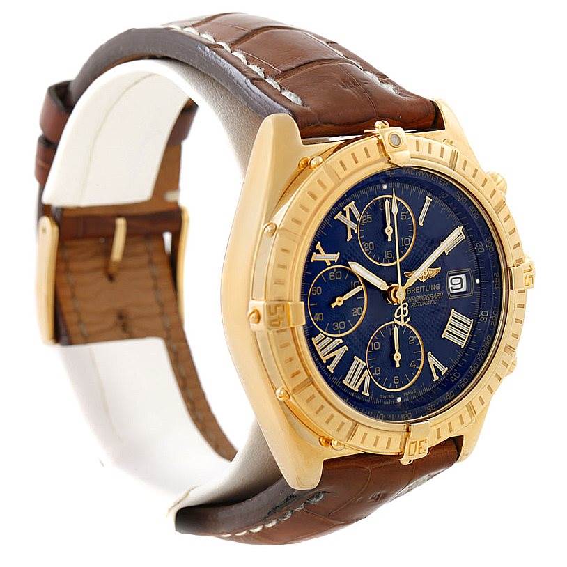 The Breitling Windrider K13055 Men
s Yellow Gold Blue Dial K13055 Men
s Yellow Gold Blue Dial watch is shown at a slight side angle, highlighting its gold case, brown strap, and blue dial with subdials.