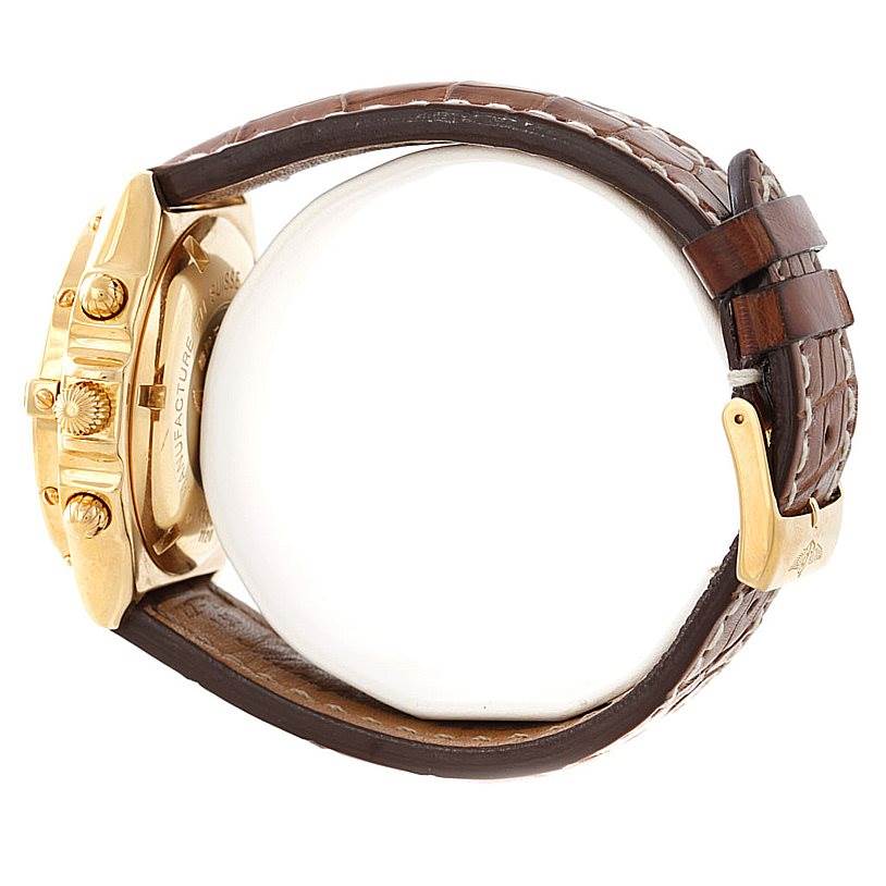 The image shows a side view of a Breitling Windrider K13055 Men
s Yellow Gold Blue Dial K13055 Men
s Yellow Gold Blue Dial watch with focus on its gold case, crown, pushers, and brown leather strap with buckle.