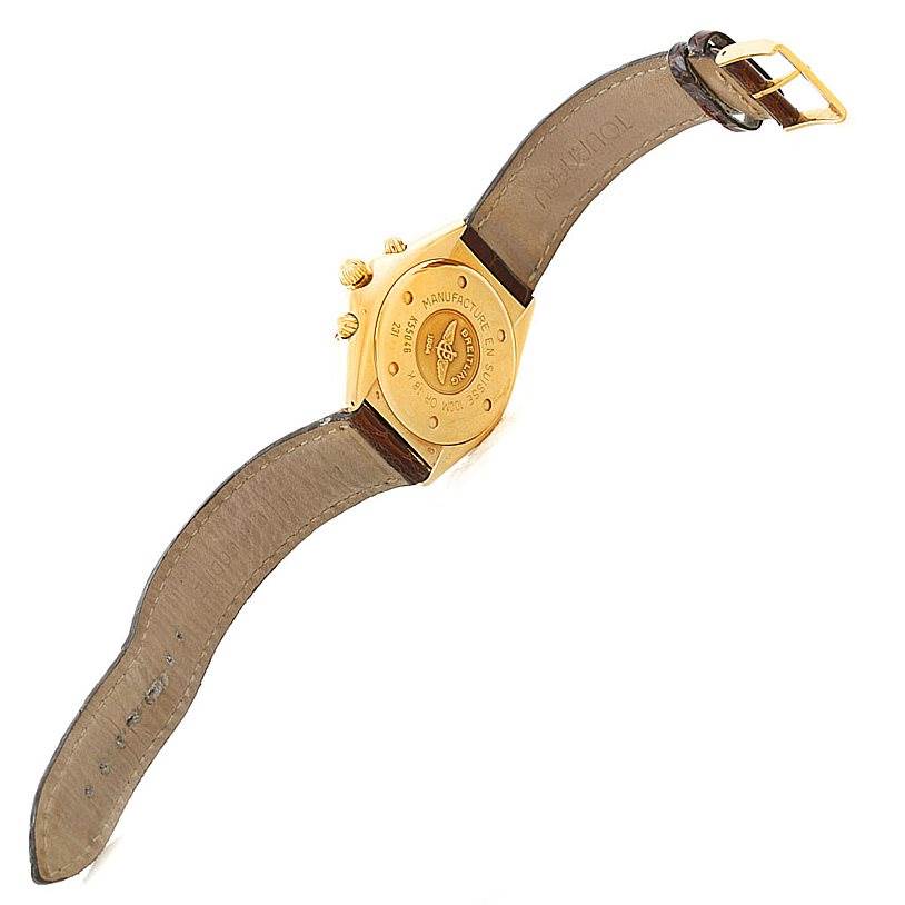 The image shows the back view of a Breitling Windrider K55046 Men's Yellow Gold White Dial K55046 Men's Yellow Gold White Dial watch with its leather strap and gold case.