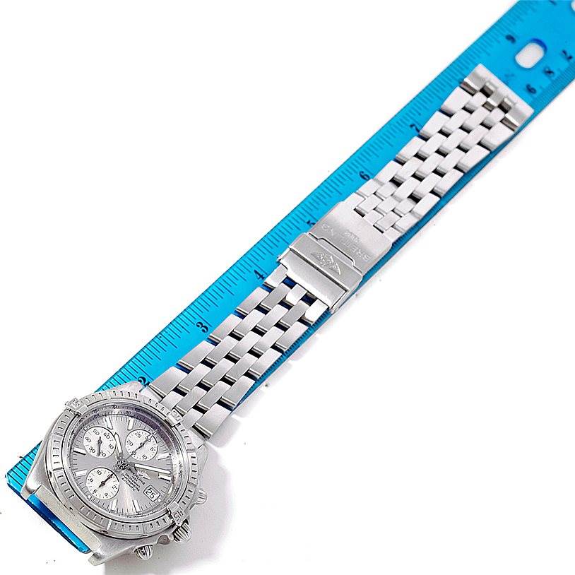 The image shows a Breitling Windrider A13355 Men's Stainless Steel Silver Dial A13355 Men's Stainless Steel Silver Dial watch laying flat, displaying the face, bracelet, and clasp, with a ruler for scale.