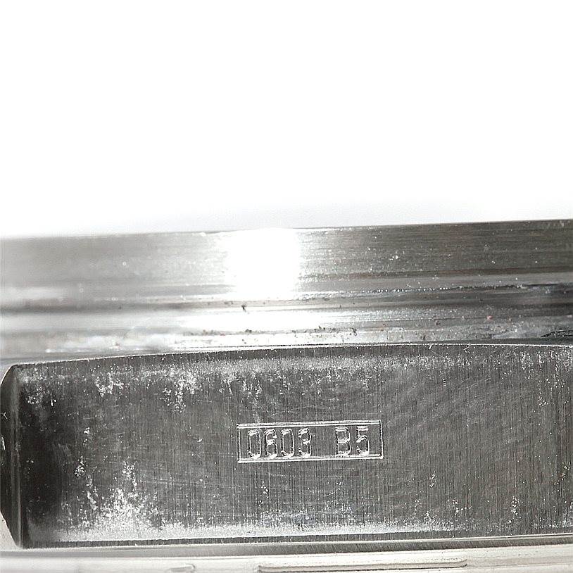 This image shows the side of a Breitling Windrider A13355 Men's Stainless Steel Silver Dial A13355 Men's Stainless Steel Silver Dial watch, highlighting its metallic case with a reference number engraved.