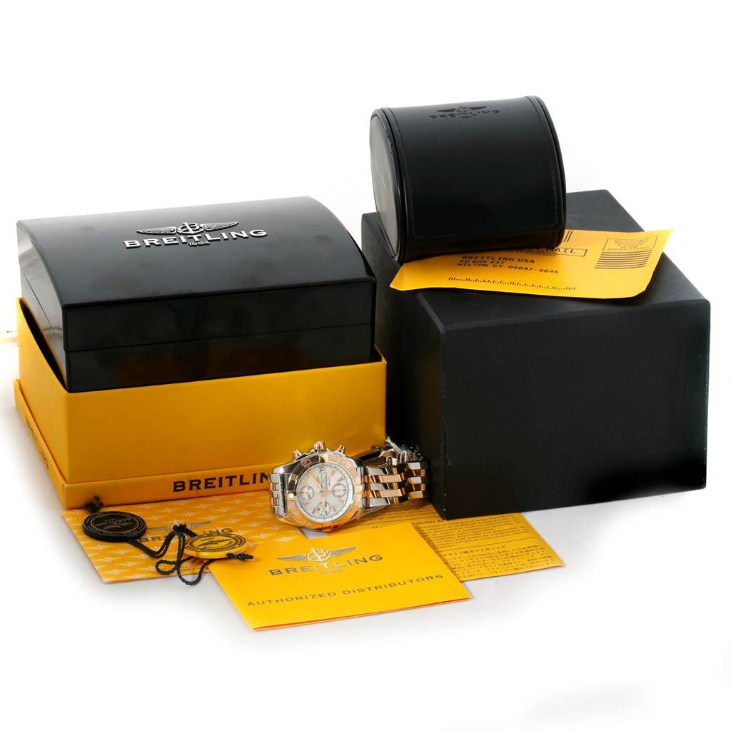 This image shows a Breitling Windrider C13358 Steel and Gold (two tone) Mother of Pearl Dial C13358 Steel and Gold (two tone) Mother of Pearl Dial model watch along with its packaging, warranty cards, and authorized distributor documents.