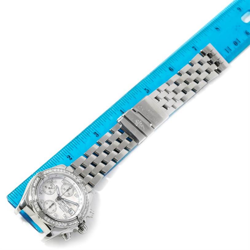 The image shows a top view of a Breitling Windrider A13358 Stainless Steel Mother of Pearl Dial A13358 Stainless Steel Mother of Pearl Dial watch with a focus on its metal strap and partially visible dial.