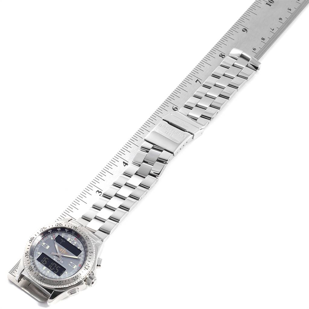 The image shows the full length of a Breitling Professional Series A68062 Men's Stainless Steel Grey Dial A68062 Men's Stainless Steel Grey Dial watch laying flat, featuring its face and metal bracelet against a ruler.