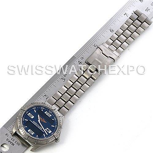 The image shows a top-down view of a Breitling Professional Series E75362 Men's Titanium Blue Dial E75362 Men's Titanium Blue Dial watch with a blue dial and stainless steel bracelet next to a ruler.