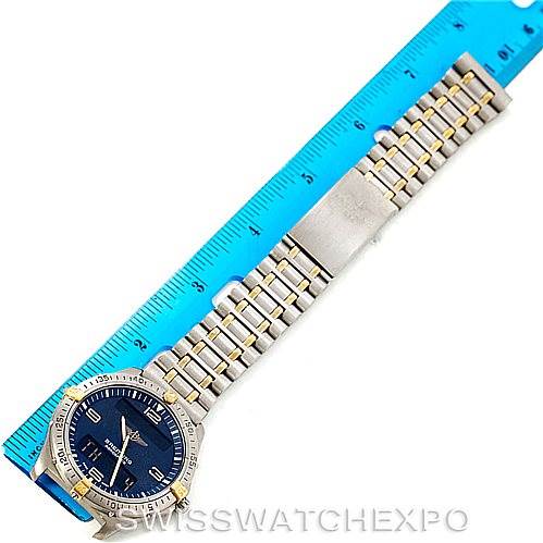 The image shows a flat-lay view of a Breitling Professional Series F56062 Men
s Titanium Blue Dial F56062 Men
s Titanium Blue Dial watch, highlighting the face, bezel, and full bracelet next to a ruler.