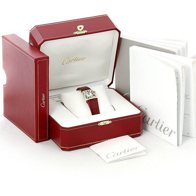 The Cartier La Dona W6400256 Women's Yellow Gold Silver Dial W6400256 Women's Yellow Gold Silver Dial watch is displayed in its open box, accompanied by booklets and packaging materials.