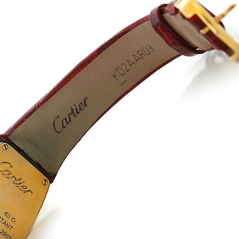 The image shows the inside of the strap and part of the clasp of a Cartier La Dona W6400256 Women's Yellow Gold Silver Dial W6400256 Women's Yellow Gold Silver Dial watch with visible brand engravings.