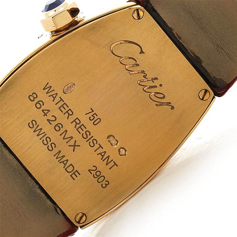 This image shows the backplate of a La Dona model watch by Cartier, displaying various inscriptions and a leather strap.