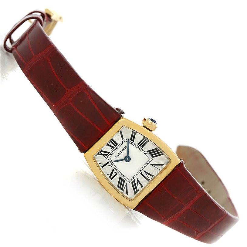This Cartier La Dona W6400256 Women's Yellow Gold Silver Dial W6400256 Women's Yellow Gold Silver Dial model watch is shown at an oblique angle, displaying the face, bezel, strap, and crown.