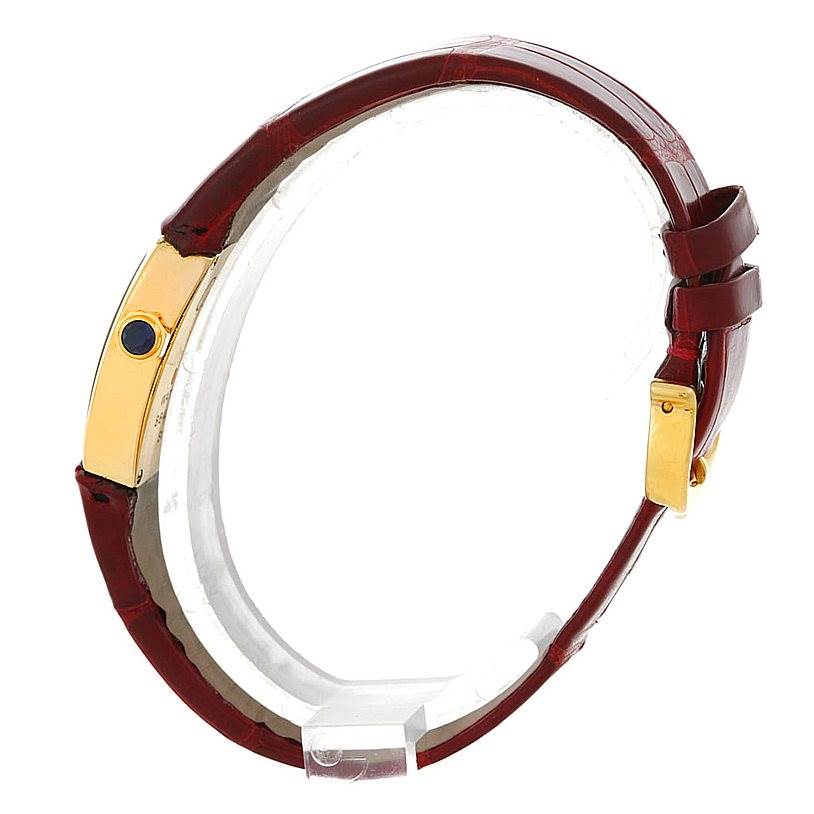 The image shows a side view of a Cartier La Dona W6400256 Women's Yellow Gold Silver Dial W6400256 Women's Yellow Gold Silver Dial watch, featuring its red leather strap and golden buckle.