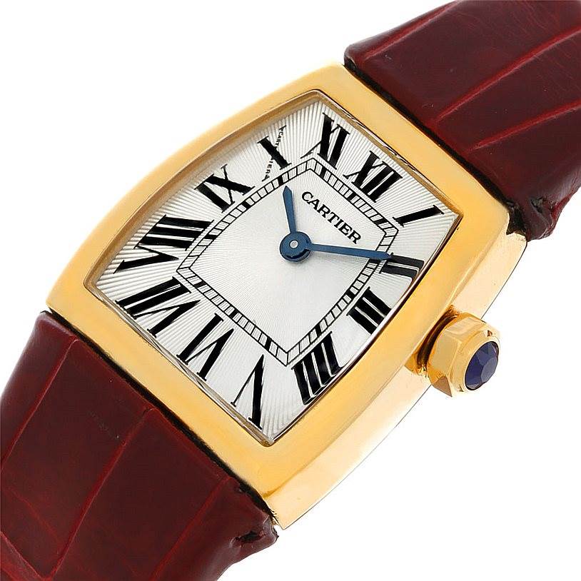 This image shows a close-up of the La Dona model by Cartier, featuring the dial, case, crown, and part of the leather strap.