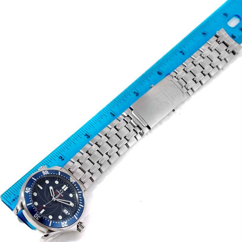 The image shows the Omega Seamaster 2226.80.00 Men
s Stainless Steel Blue Dial 2226.80.00 Men
s Stainless Steel Blue Dial watch laying flat next to a ruler, displaying the watch face, bezel, and metal bracelet.