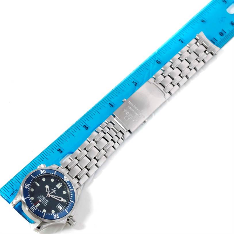 The image shows the full view of the Omega Seamaster 2551.80.00 Men
s Stainless Steel Blue Dial 2551.80.00 Men
s Stainless Steel Blue Dial watch, including its face, bezel, and bracelet, next to a ruler for scale.