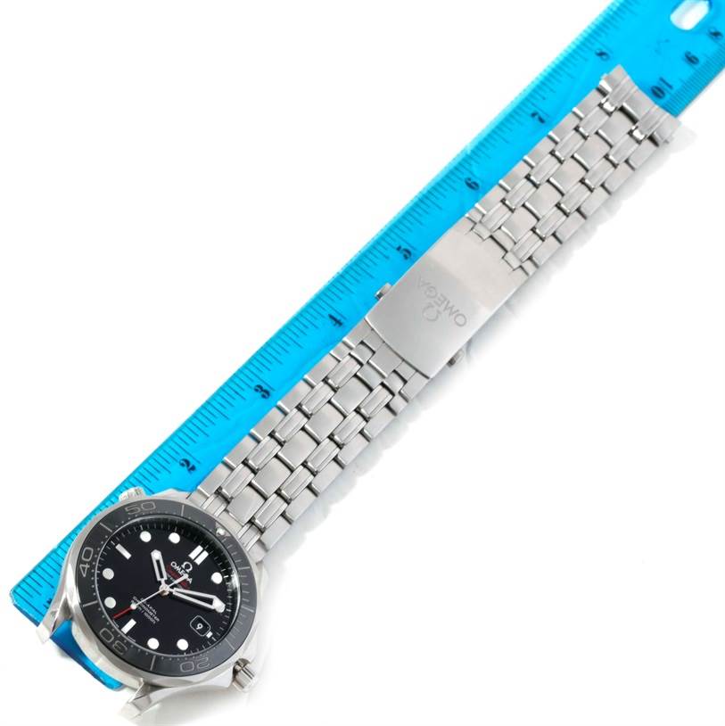 The image shows an Omega Seamaster 212.30.41.20.01.002 Men
s Stainless Steel Black Dial 212.30.41.20.01.002 Men
s Stainless Steel Black Dial watch laid flat next to a ruler, highlighting its face, bezel, and metallic bracelet with clasp.