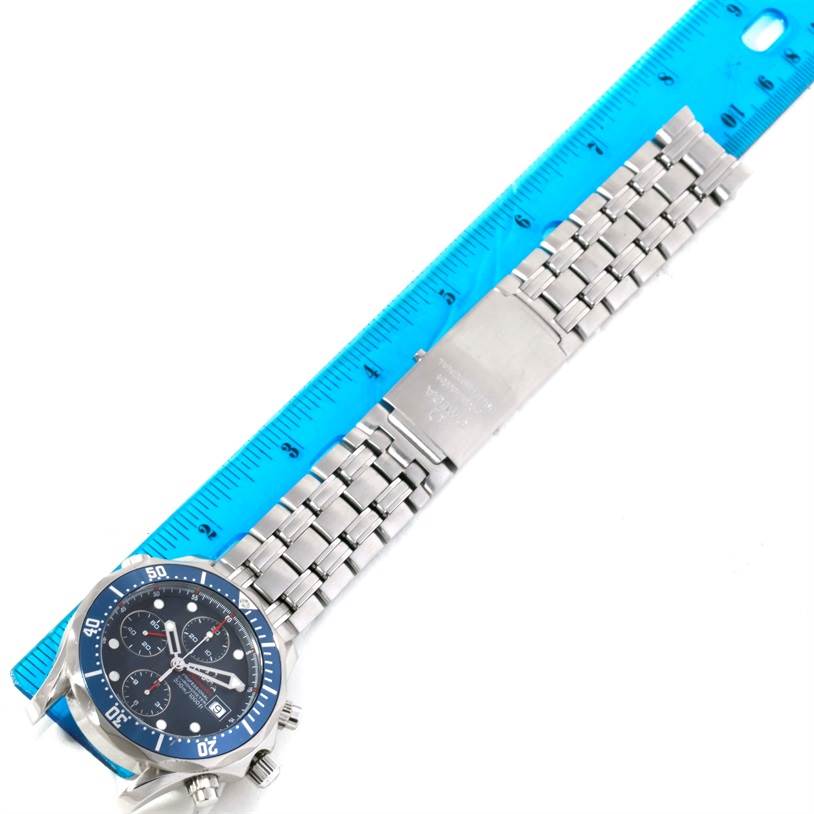 The image shows an overhead view of an Omega Seamaster 2225.80.00 Men
s Stainless Steel Blue Dial 2225.80.00 Men
s Stainless Steel Blue Dial watch, featuring the dial, bezel, and stainless steel bracelet next to a ruler.