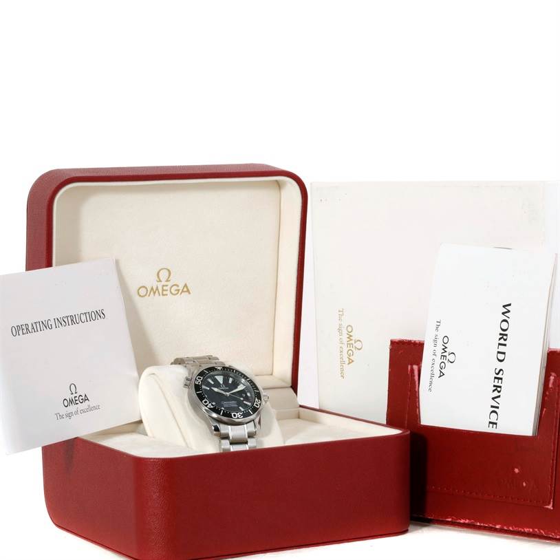 The image shows an Omega Seamaster 2262.50.00 Men
s Stainless Steel Black Dial 2262.50.00 Men
s Stainless Steel Black Dial watch at an angled view in its open case with accompanying operating instructions and service booklet.