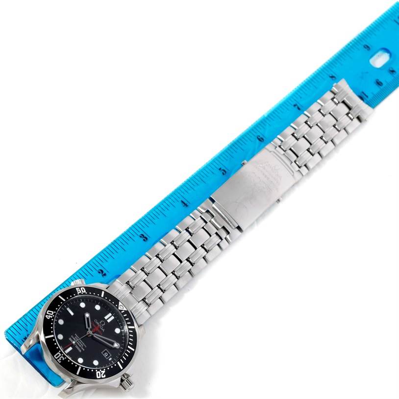 The Omega Seamaster 212.30.41.20.01.001 Men
s Stainless Steel Black Dial 212.30.41.20.01.001 Men
s Stainless Steel Black Dial watch is shown laid flat with a blue ruler measuring its metal bracelet and clasp.